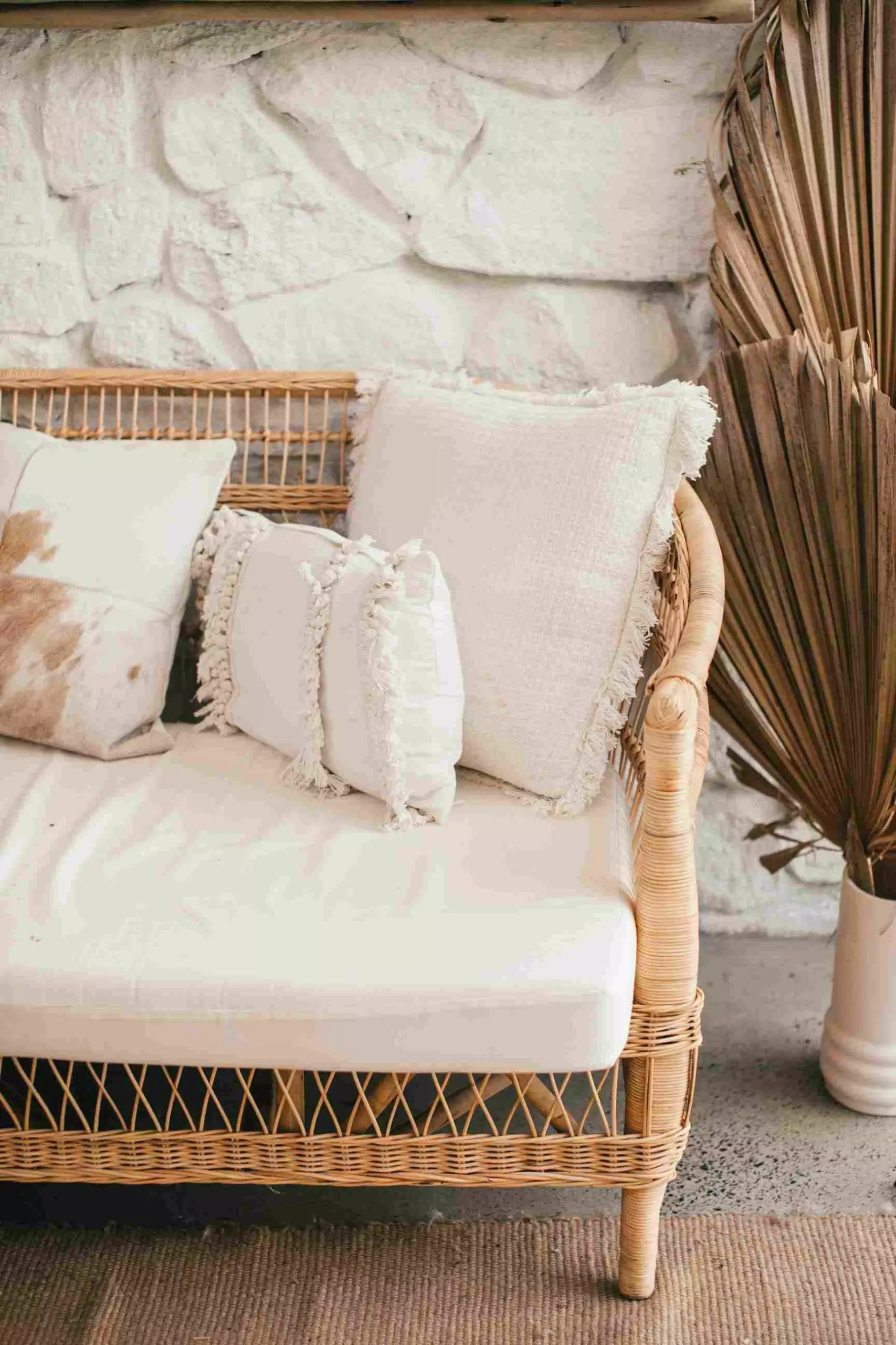Wicker sofa with white cushions